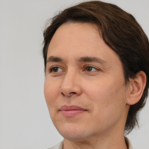 Joyful white young-adult male with medium  brown hair and brown eyes