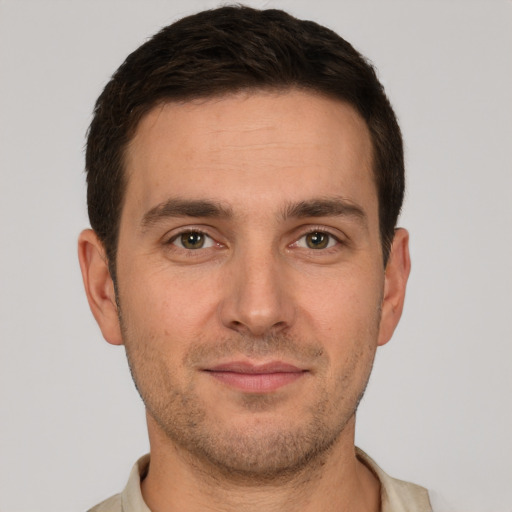 Joyful white young-adult male with short  brown hair and brown eyes