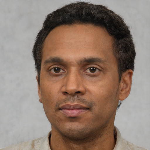 Neutral latino adult male with short  black hair and brown eyes