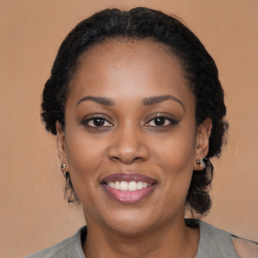 Joyful black young-adult female with medium  black hair and brown eyes