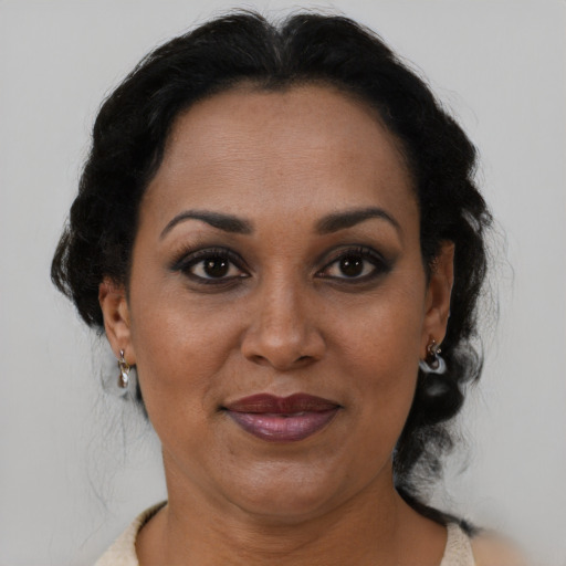 Joyful black adult female with short  brown hair and brown eyes