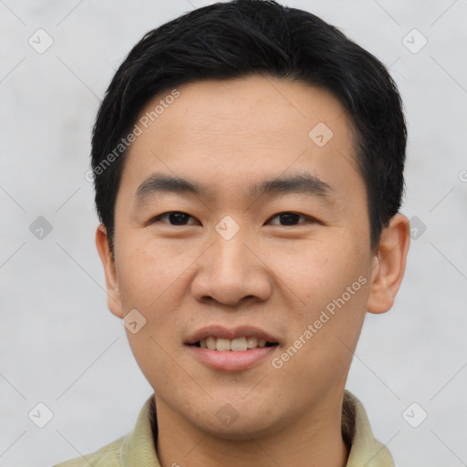 Joyful asian young-adult male with short  brown hair and brown eyes