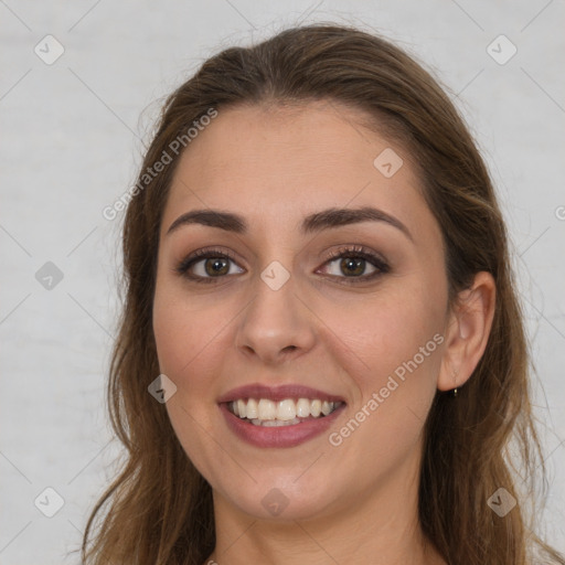 Joyful white young-adult female with long  brown hair and brown eyes