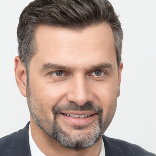 Joyful white adult male with short  brown hair and brown eyes