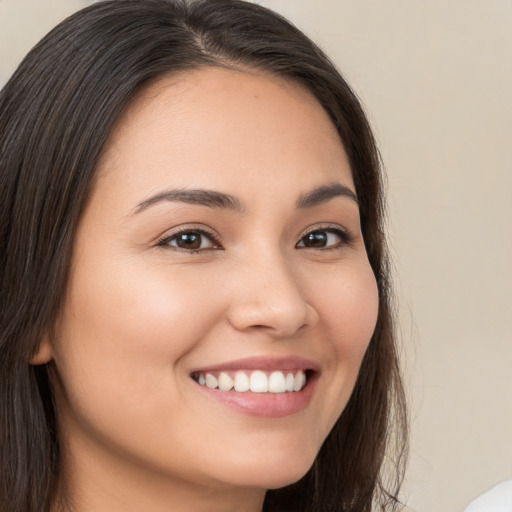 Joyful white young-adult female with long  brown hair and brown eyes