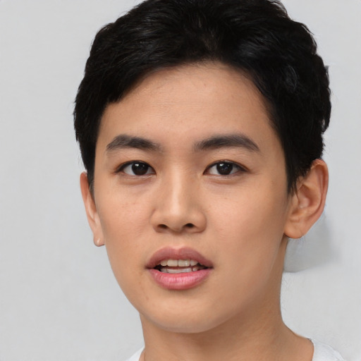 Joyful asian young-adult male with short  black hair and brown eyes