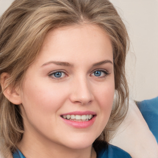 Joyful white young-adult female with medium  brown hair and blue eyes