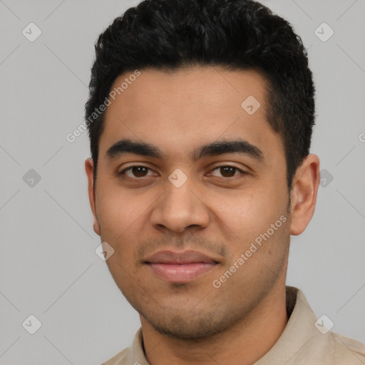 Joyful latino young-adult male with short  black hair and brown eyes