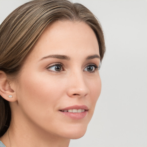 Joyful white young-adult female with long  brown hair and grey eyes