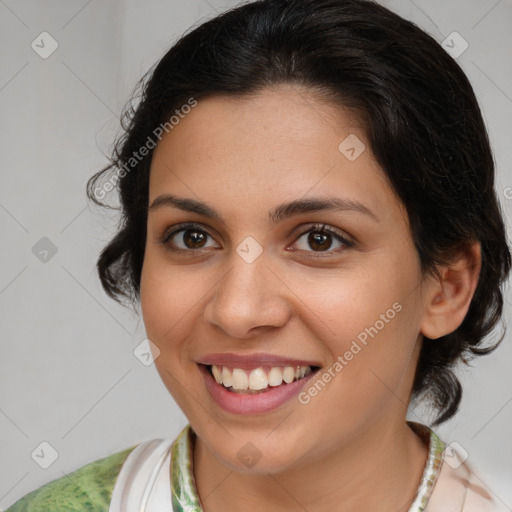 Joyful latino young-adult female with medium  brown hair and brown eyes