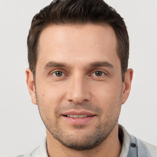 Joyful white young-adult male with short  brown hair and brown eyes