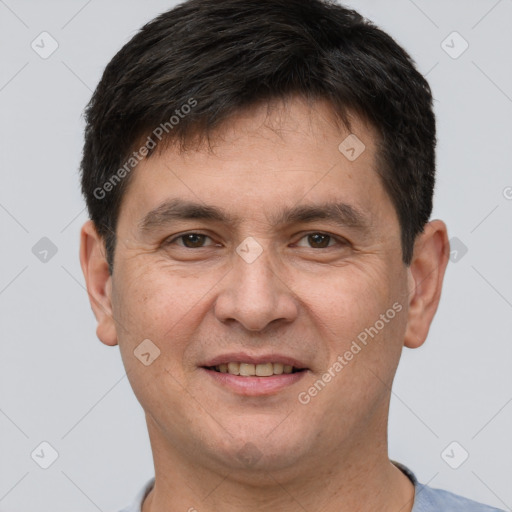 Joyful white adult male with short  brown hair and brown eyes