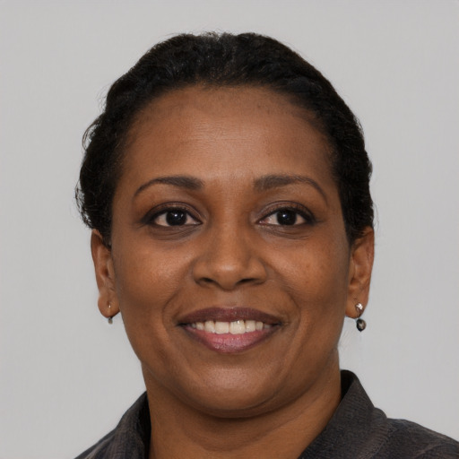 Joyful black adult female with short  brown hair and brown eyes