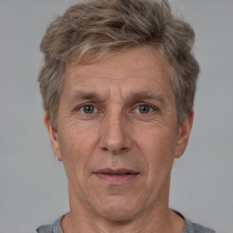 Joyful white middle-aged male with short  brown hair and brown eyes