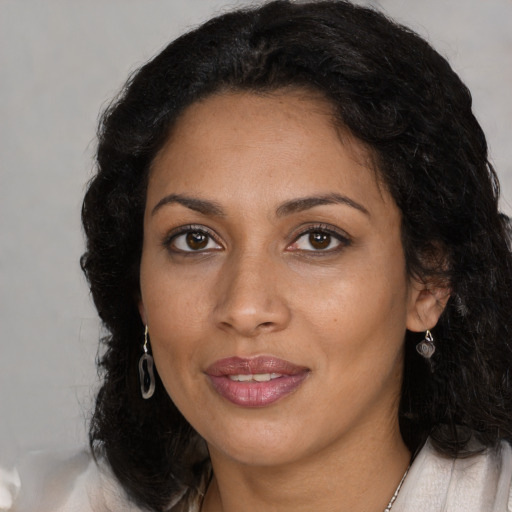 Joyful latino young-adult female with medium  black hair and brown eyes