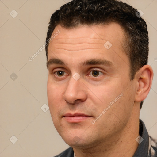 Joyful white adult male with short  brown hair and brown eyes