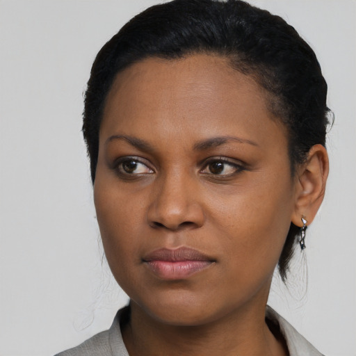 Joyful black young-adult female with medium  black hair and brown eyes