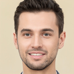 Joyful white young-adult male with short  brown hair and brown eyes