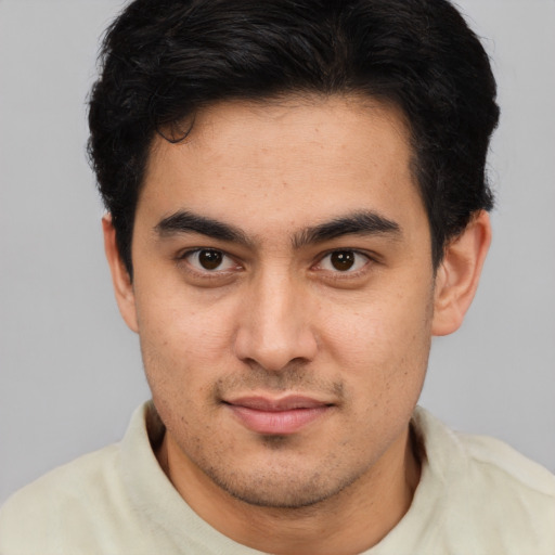 Joyful latino young-adult male with short  brown hair and brown eyes