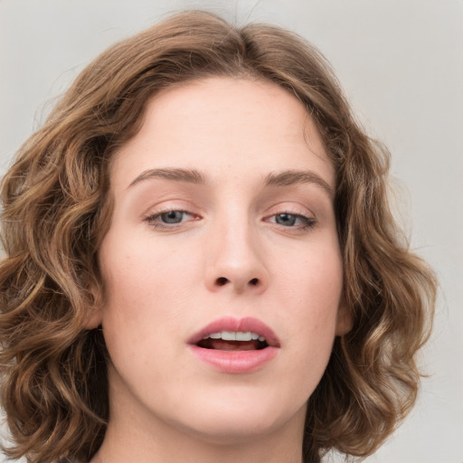 Joyful white young-adult female with medium  brown hair and green eyes