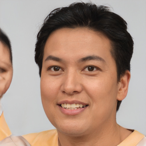 Joyful asian young-adult female with short  brown hair and brown eyes