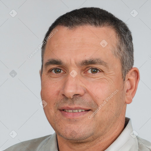 Joyful white adult male with short  black hair and brown eyes