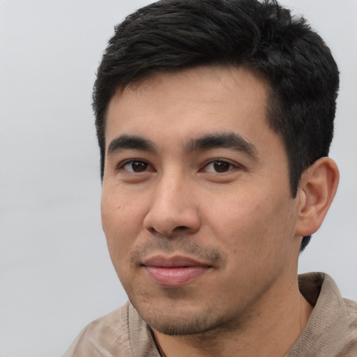 Joyful asian young-adult male with short  black hair and brown eyes