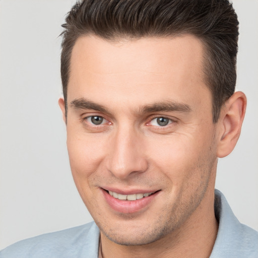 Joyful white young-adult male with short  brown hair and brown eyes