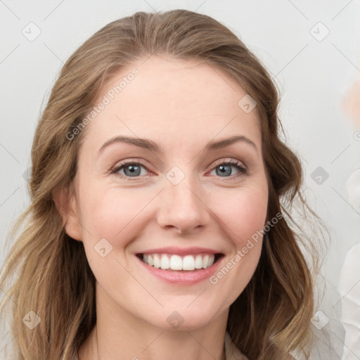 Joyful white young-adult female with long  brown hair and blue eyes