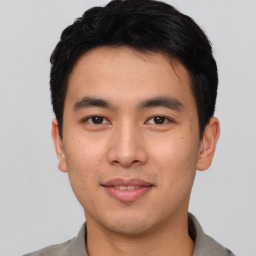 Joyful asian young-adult male with short  black hair and brown eyes