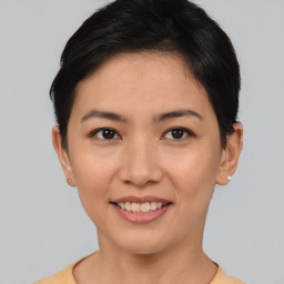 Joyful asian young-adult female with short  black hair and brown eyes