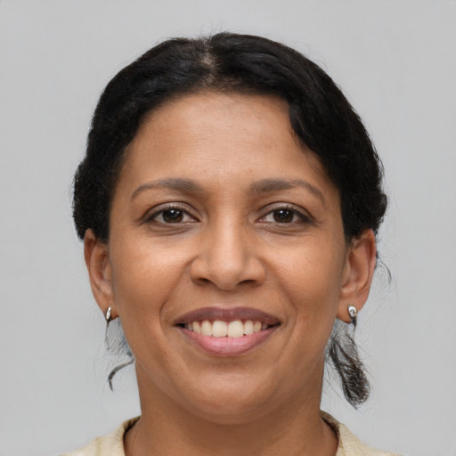 Joyful latino adult female with short  brown hair and brown eyes