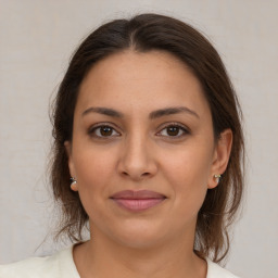 Joyful white young-adult female with medium  brown hair and brown eyes