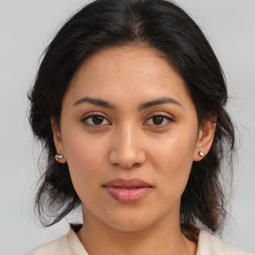 Joyful latino young-adult female with medium  brown hair and brown eyes