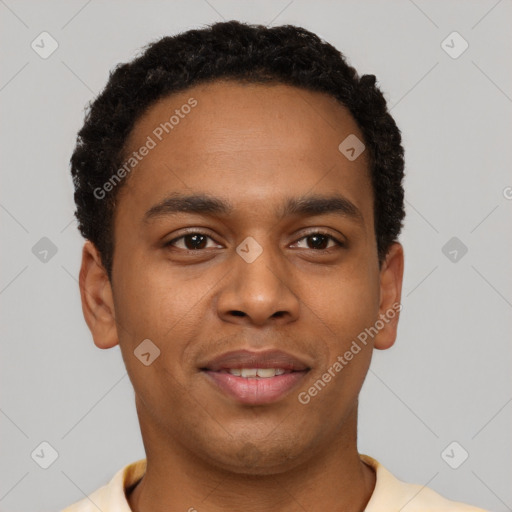 Joyful black young-adult male with short  brown hair and brown eyes