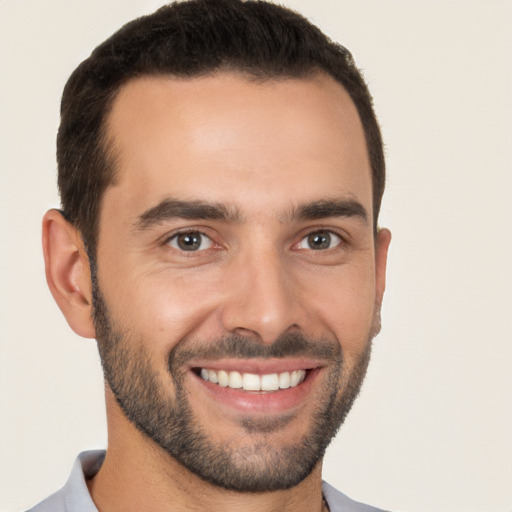 Joyful white young-adult male with short  black hair and brown eyes