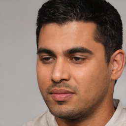 Joyful white young-adult male with short  black hair and brown eyes