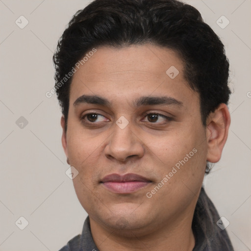 Joyful white young-adult male with short  black hair and brown eyes