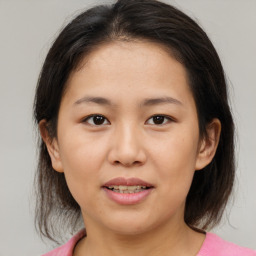 Joyful asian young-adult female with medium  brown hair and brown eyes