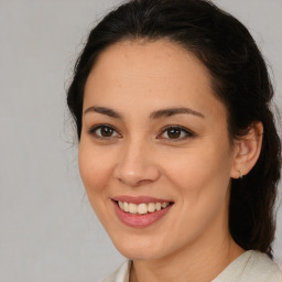 Joyful latino young-adult female with medium  brown hair and brown eyes