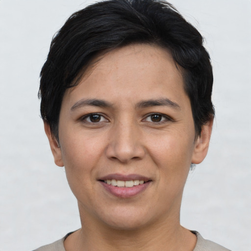 Joyful white young-adult female with short  black hair and brown eyes