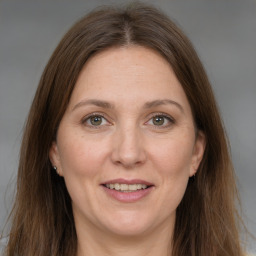 Joyful white adult female with long  brown hair and brown eyes