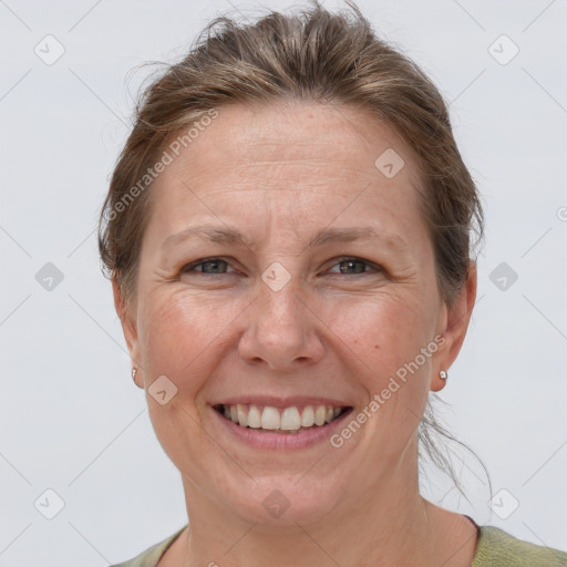 Joyful white adult female with short  brown hair and grey eyes