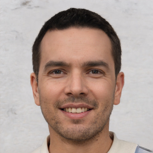 Joyful white young-adult male with short  black hair and brown eyes