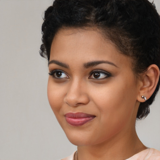 Joyful latino young-adult female with short  black hair and brown eyes