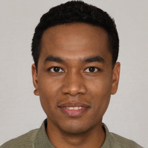 Joyful black young-adult male with short  black hair and brown eyes