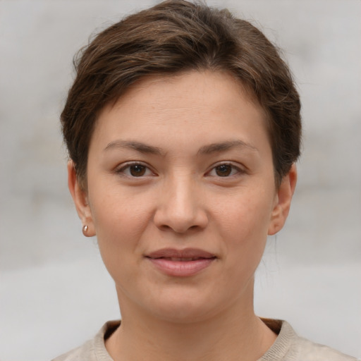 Joyful white young-adult female with short  brown hair and grey eyes