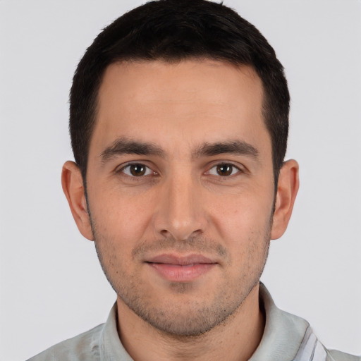 Joyful white young-adult male with short  black hair and brown eyes