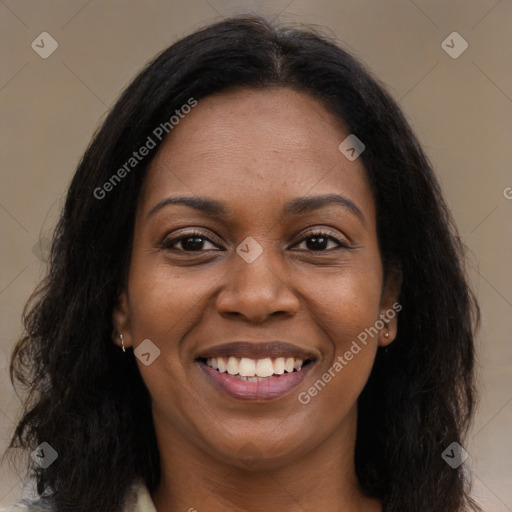 Joyful black young-adult female with long  brown hair and brown eyes