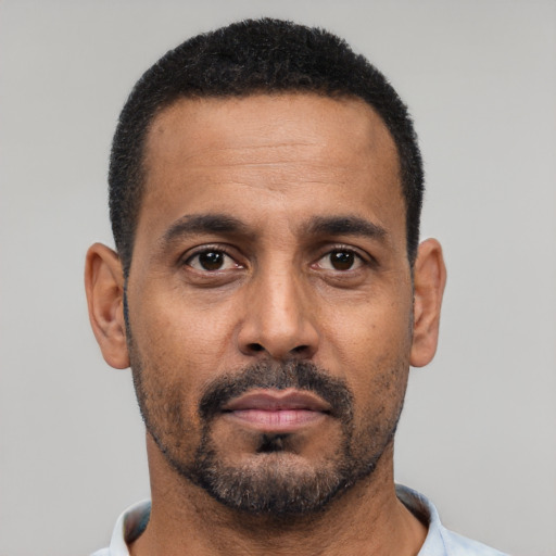 Neutral black adult male with short  black hair and brown eyes
